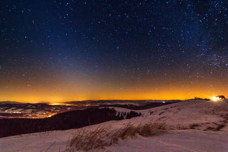 Sunset and stars at dusk in Carpathian mountain range.の写真素材