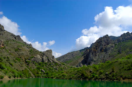 Beautiful sunny valley between the mountains with lush clouds in the Crimea, Ukraineの写真素材