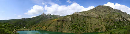 Beautiful sunny valley between the mountains with lush clouds in the Crimea, Ukraineの写真素材