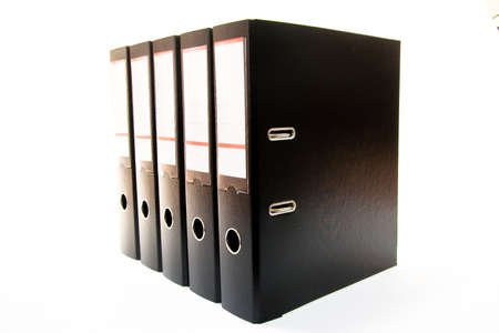row of folders for papers and documentation on a shelf in the officeの写真素材