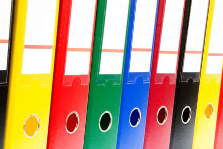 row of folders for papers and documentation on a shelf in the officeの写真素材