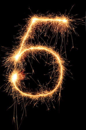 Burning Sparkling number 0 zero isolated on black background. Beautiful Glowing design element for greeting card, holiday flyer.の写真素材