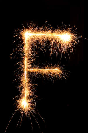 Burning Sparkling number 0 zero isolated on black background. Beautiful Glowing design element for greeting card, holiday flyer.の写真素材