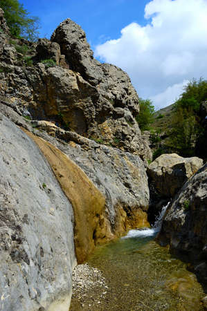 Long exposure view of a hidden river in Crimea, Ukraine. A stone set against a blurred water pattern is ideal for background use.の写真素材