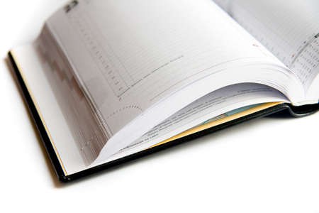 Business diary with a pen on a white backgroundの写真素材