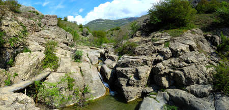 Long exposure view of a hidden river in Crimea, Ukraine. A stone set against a blurred water pattern is ideal for background use.の写真素材