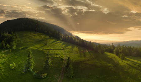 Wide-angle panoramic shot of beautiful meadows, hills and trees in Synevyrska glade next to Synevyr lake. Majestic and wonderful landscapes of the Carpathian mountains in Ukraineの写真素材
