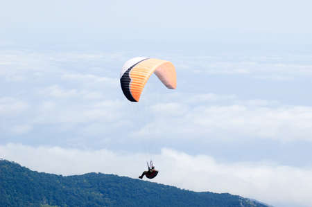 Enjoy the freedom with a paragliding flightの写真素材