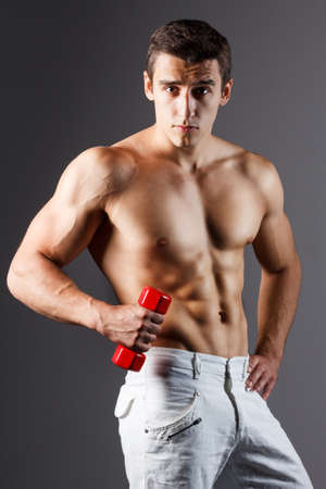 pain relief, sport, bodybuilding, strength and people concept - young man standing over black backgroundの写真素材