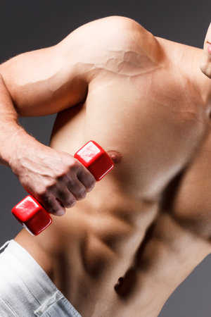 pain relief, sport, bodybuilding, strength and people concept - young man standing over black backgroundの写真素材