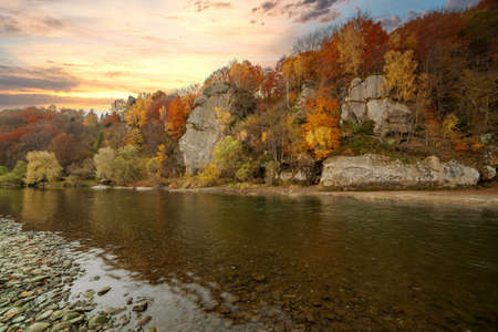 View of the waterfall in autumn. Waterfall in autumn colors. Mountain river in the autumn landscape. Ukraine, river Stryj.の写真素材