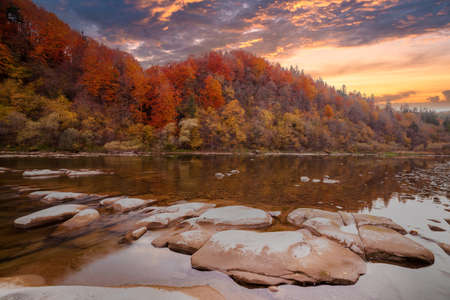 View of the waterfall in autumn. Waterfall in autumn colors. Mountain river in the autumn landscape. Ukraine, river Stryj.の写真素材