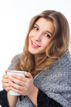 A woman in a bathrobe holds a mug of water. The woman drinks a lot of water. She drank a lot and stayed at home. close-up. isolated.の写真素材