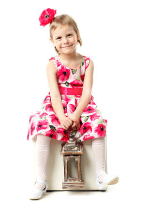 Beautiful little girl swinging on a swing. The concept of family happiness, summer holidays. Isolated on white background.の写真素材