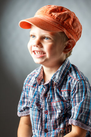 Cute boy wearing shirt hat and mustacheの写真素材
