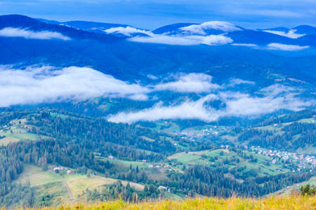 Autumn landscape with fog in the mountains. Fir forest on the hills.の写真素材