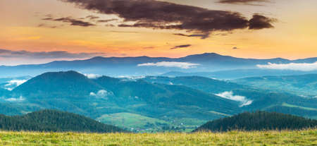 Autumn landscape with fog in the mountains. Fir forest on the hills.の写真素材