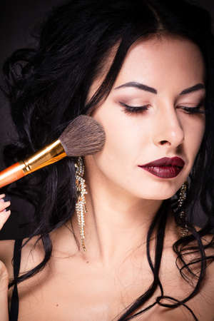 Beauty woman hold makeup professional tools mascara eyelashes brushes have clear healthy face portrait on white backgroundの写真素材