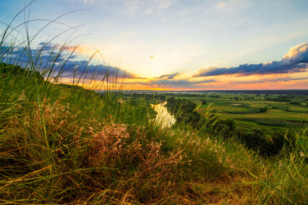 A beautiful valley with a river, blue sky with large clouds and bright sun. Aerialの写真素材