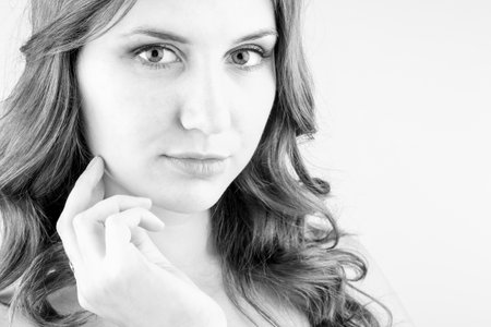 Portrait of beautiful woman with bright make up holding pink daisy in handsの写真素材