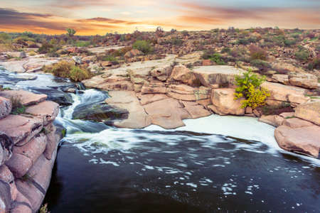 Beautiful mountain river flowing over rocks. Flow of water in mountain river close upの写真素材