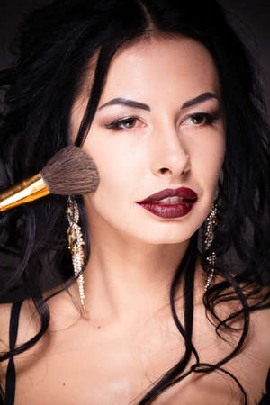 Beauty woman hold makeup professional tools mascara eyelashes brushes have clear healthy face portrait on white backgroundの写真素材