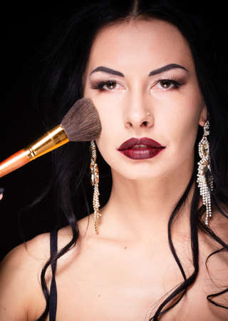 Beauty woman hold makeup professional tools mascara eyelashes brushes have clear healthy face portrait on white backgroundの写真素材