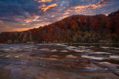 View of the waterfall in autumn. Waterfall in autumn colors. Mountain river in the autumn landscape. Ukraine, river Stryj.の写真素材