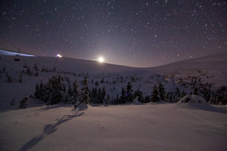 Fantastic starry sky. Winter landscape and snow-capped peaks. Carpathian mountains. Ukraine. Europeの写真素材