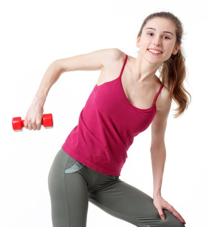 Fitness Workout. Sporty Woman Doing Bicycle Crunch Abs Exercise Lying On Floor Over Pink And Blue Neon Studio Background. Determined Lady Wearing White Fitwear Training Flexing Abdominal Musclesの写真素材