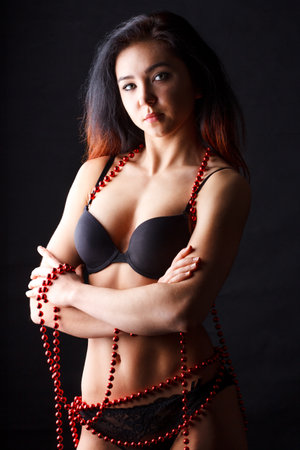 Sensual brunette Yong Woman Posing On Wooden Floor. Studio Photoshootの写真素材