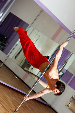 Ukrainian gymnast doing gymnastics with aerial hoop or aerial hoop in the fitness room.の写真素材