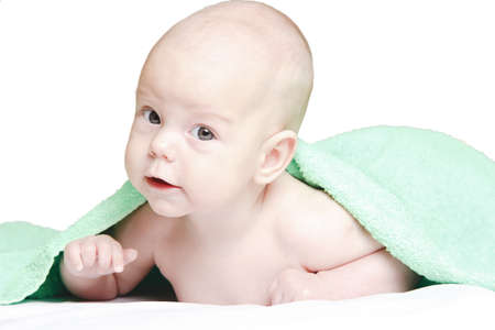 Nice thoughtful child after the washing, wrapped up in a towelの写真素材