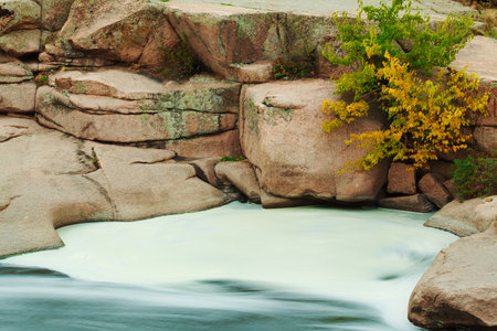 Beautiful mountain river flowing over rocks. Flow of water in mountain river close upの写真素材