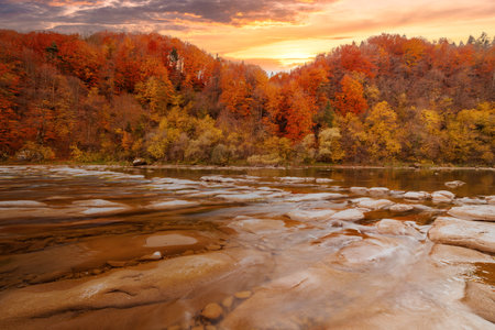 View of the waterfall in autumn. Waterfall in autumn colors. Mountain river in the autumn landscape. Ukraine, river Stryj.の写真素材