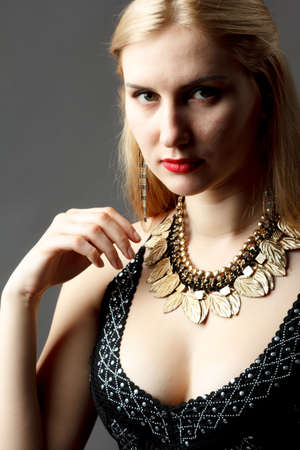 Woman putting on diamond earrings. Caucasian beauty lady trying and shopping jewelry.の写真素材