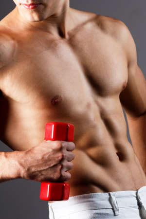 pain relief, sport, bodybuilding, strength and people concept - young man standing over black backgroundの写真素材