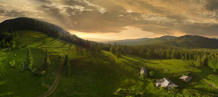 Wide-angle panoramic shot of beautiful meadows, hills and trees in Synevyrska glade next to Synevyr lake. Majestic and wonderful landscapes of the Carpathian mountains in Ukraineの写真素材