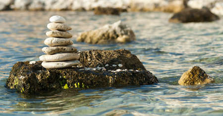 Wonderful nature Shining and polished stones piled on the shore with many polished stones on the Crimean peninsula. The background is the sea, a pebble beach with some other islands.の写真素材