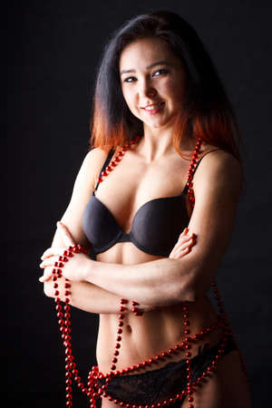 Sensual brunette Yong Woman Posing On Wooden Floor. Studio Photoshootの写真素材