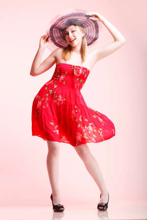 Beautiful woman happy screaming in red dressの写真素材