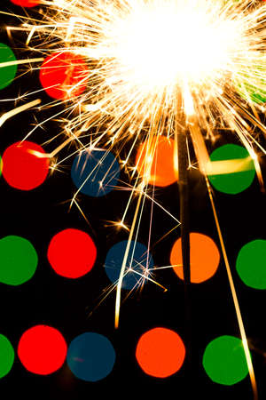 Sparkler background. A sparkler is a type of hand held firework that burns slowly while emitting colored flames, sparks, and other effectsの写真素材