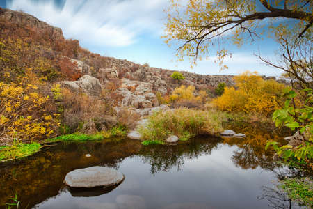 A small wonderful lake along a picturesque river flowing through a beautiful canyon. Huge hatches are in the water. Ukraine.の写真素材