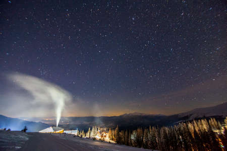 Fantastic starry sky. Winter landscape and snow-capped peaks. Carpathian mountains. Ukraine. Europeの写真素材