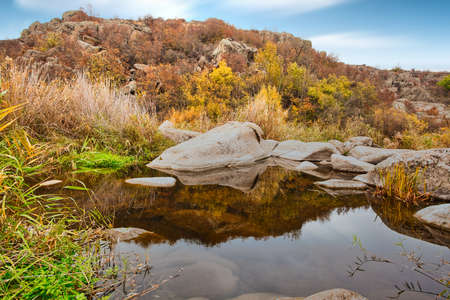 A small wonderful lake along a picturesque river flowing through a beautiful canyon. Huge hatches are in the water. Ukraine.の写真素材