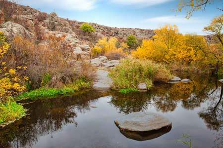 A small wonderful lake along a picturesque river flowing through a beautiful canyon. Huge hatches are in the water. Ukraine.の写真素材