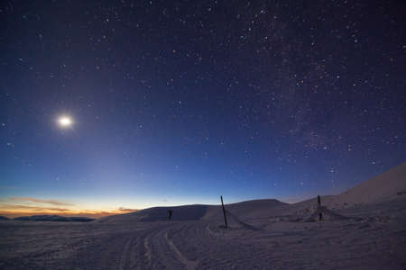 Fantastic starry sky. Winter landscape and snow-capped peaks. Carpathian mountains. Ukraine. Europeの写真素材