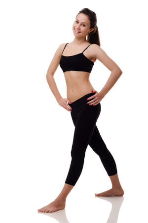 Young, fit and beautiful brunette woman in sportswear isolated on grey. Health care, diet, sport and fitness concept.の写真素材