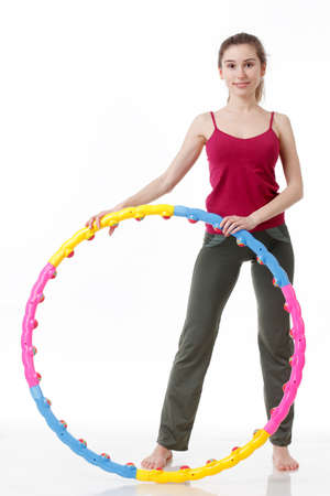 Fitness Workout. Sporty Woman Doing Bicycle Crunch Abs Exercise Lying On Floor Over Pink And Blue Neon Studio Background. Determined Lady Wearing White Fitwear Training Flexing Abdominal Musclesの写真素材