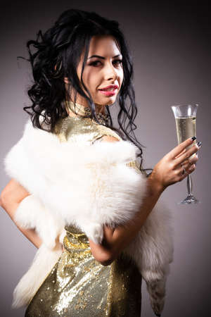 Portrait a beautiful woman in a golden gownの写真素材